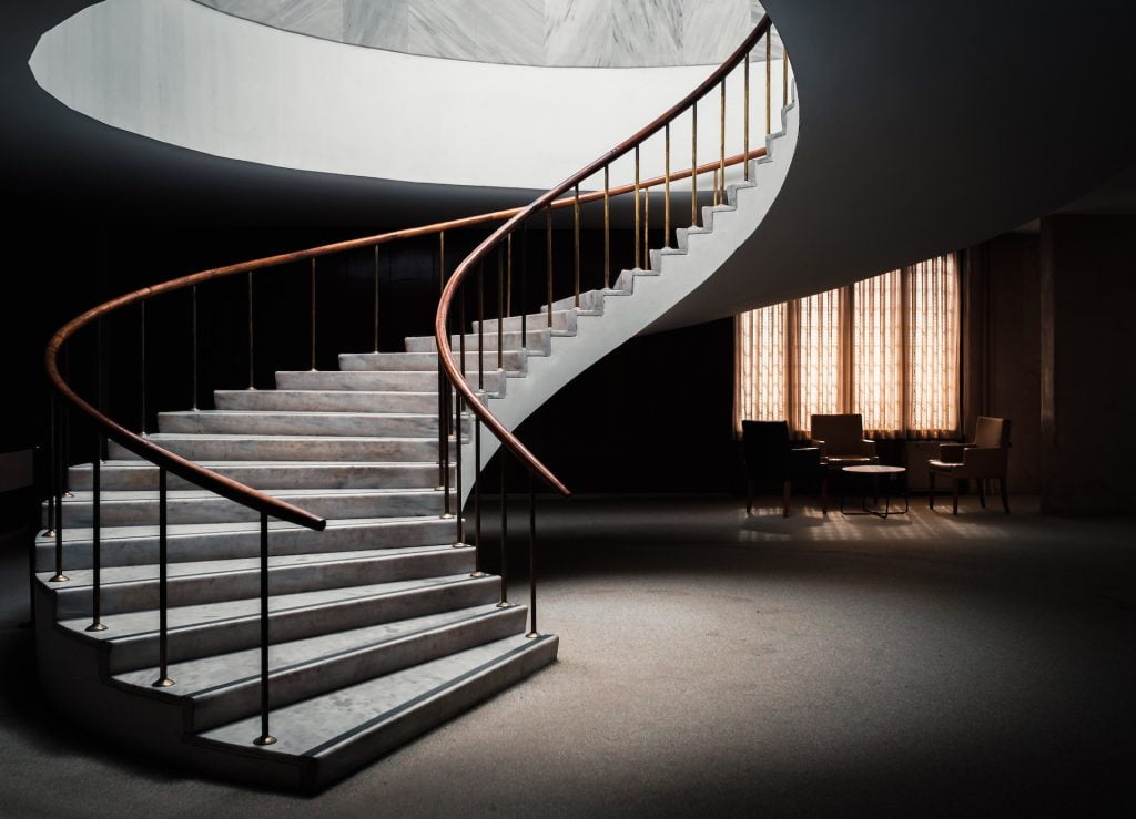 Check out the grand curved stairs that is usually only available in landed Singapore homes